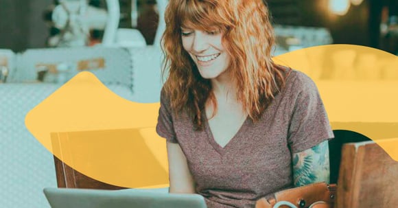 woman smiling looking at computer screen