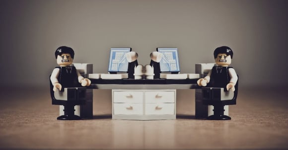 Two lego men in a small lego office